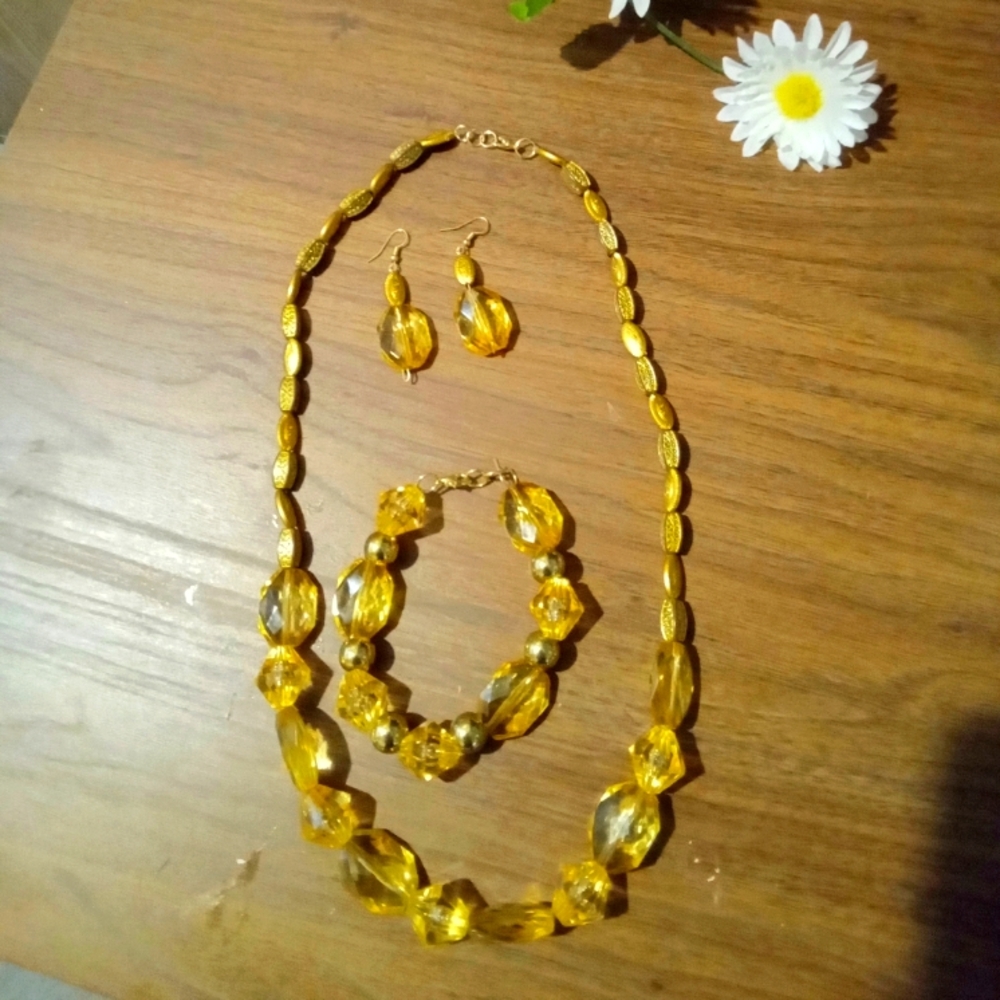 Gold beads necklace with a matching bracelet and earings.